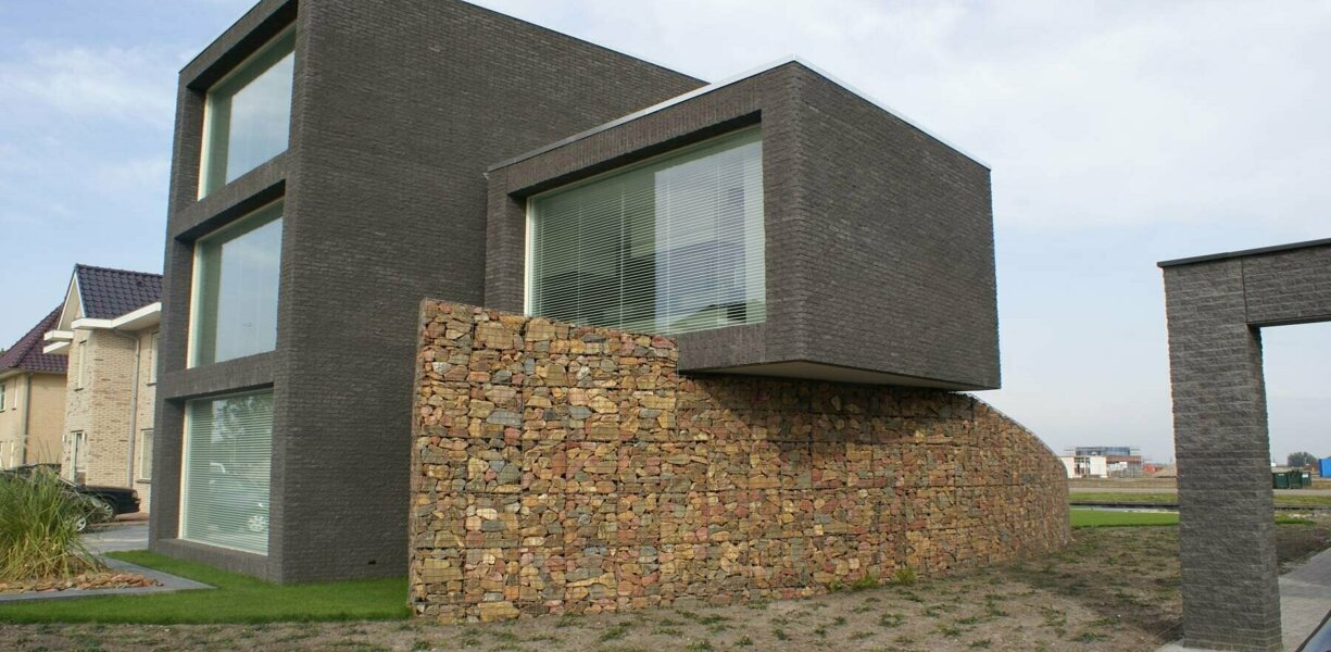 gevelbekleding woonhuis met schanskorven